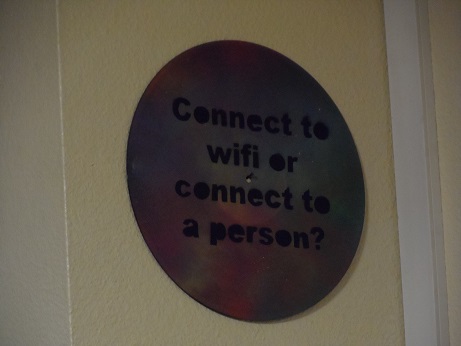 A sign saying: "Connect to wifi or connect to a person?"